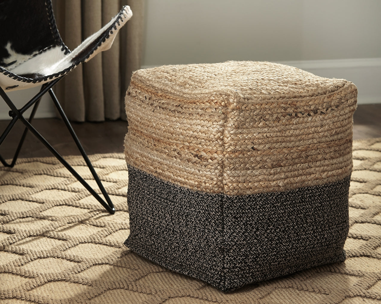 Haines Furniture Outlet - Ashley Furniture - Sweed Valley Pouf - Pouf / Natural/Black - A1000422