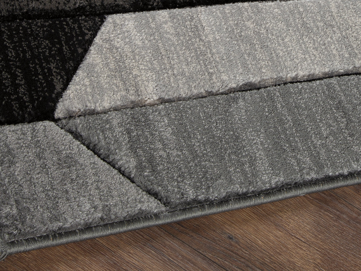 Haines Furniture Outlet - Ashley Furniture - Chayse Rug - 5' x 6'7" Rug / Black/Gray - R403462