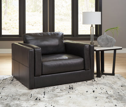 Haines Furniture Outlet - Ashley Furniture - Amiata Living Room - Chair and a Half / Onyx - 5740523