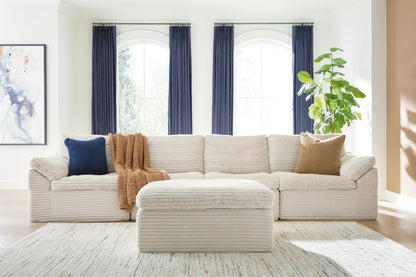 Haines Furniture Outlet - Ashley Furniture - Fannin Sectional - RAF 4-Piece Sectional with Ottoman / Ivory - PC84304S1