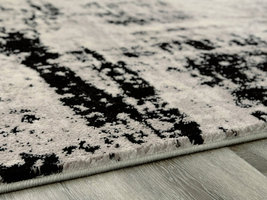 Haines Furniture Outlet - Ashley Furniture - Zekeman Rug - 7'10" x 10' Rug / Black/Cream/Gray - R404921
