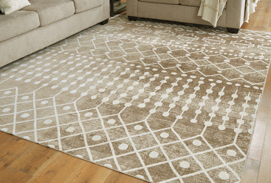 Haines Furniture Outlet - Ashley Furniture - Bunchly Rug - 4'11" x 7'2" Washable Rug / Tan/Brown/Cream - R406222