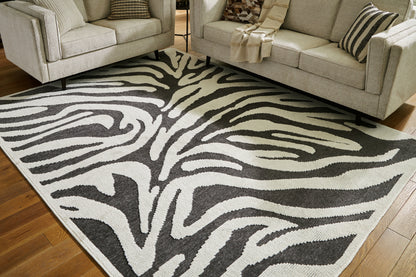 Haines Furniture Outlet - Ashley Furniture - Thomwith Rug - 8' x 10'2" Washable Rug / Black/Ivory - R406291