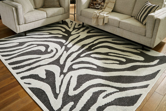 Haines Furniture Outlet - Ashley Furniture - Thomwith Rug - 8' x 10'2" Washable Rug / Black/Ivory - R406291