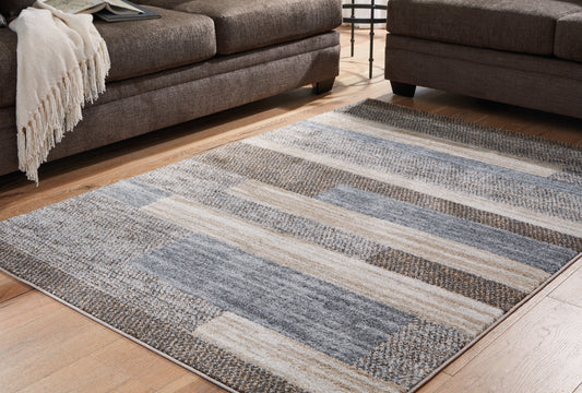 Haines Furniture Outlet - Ashley Furniture - Sethburn Rug - 5' x 7' Rug / Cream/Brown/Gray - R406592