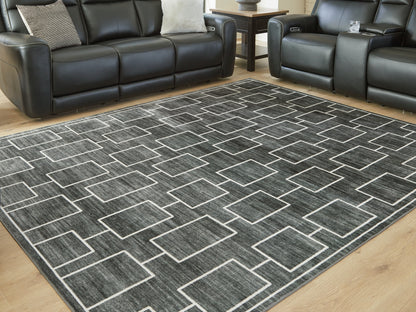 Haines Furniture Outlet - Ashley Furniture - Elderland Rug - Washable 7'6" x 9'6" Area Rug / Black/Gray - R407401