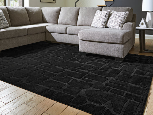 Haines Furniture Outlet - Ashley Furniture - Gibbswell Rug - Washable 5' x 7' Area Rug / Black - R407462