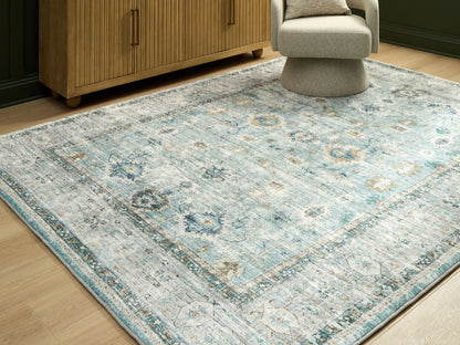 Haines Furniture Outlet - Ashley Furniture - Ladstoney Rug - 7'6" x 9'6" Area Rug / Teal/Beige/Ochre - R407501