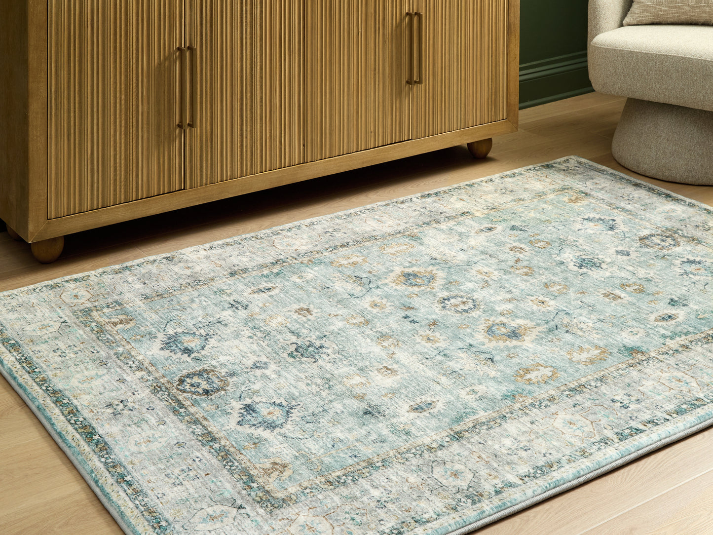 Haines Furniture Outlet - Ashley Furniture - Ladstoney Rug - 7'6" x 9'6" Area Rug / Teal/Beige/Ochre - R407501