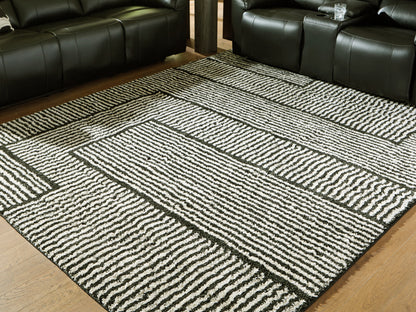 Haines Furniture Outlet - Ashley Furniture - Kurtmen Rug - 5' x 7' Area Rug / Black/Ivory - R407592