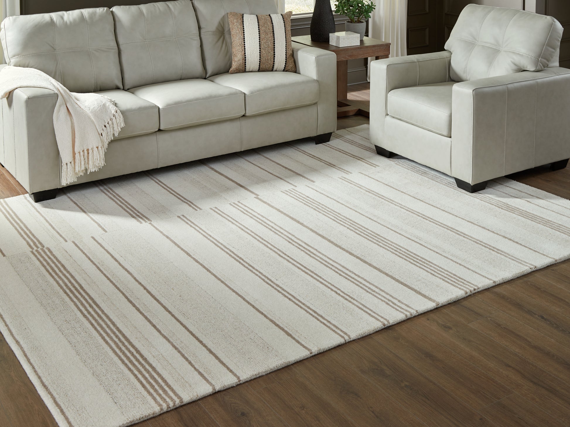 Haines Furniture Outlet - Ashley Furniture - Gadence Rug - 5' x 7' Area Rug / Ivory/Tan - R407642