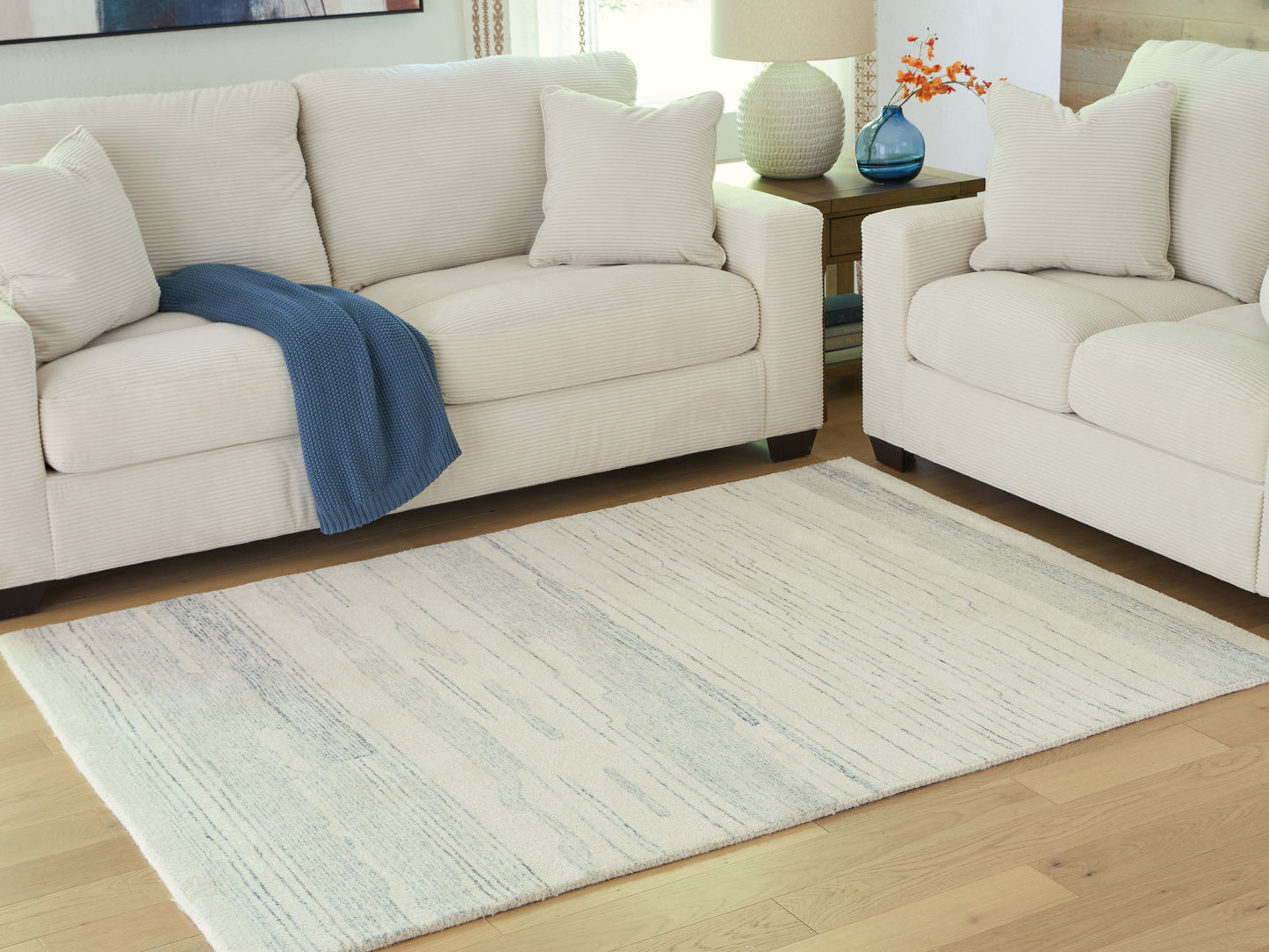 Haines Furniture Outlet - Ashley Furniture - Genemost Rug - 5' x 7' Area Rug / Ivory/Blue - R407842